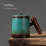 Full product view of vintage emerald ceramic tea infuser mug with wooden handle