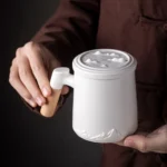 full set view of 380ml mountain relief ceramic travel tea infuser mug with wooden handle