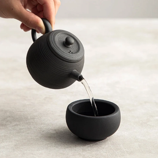 Black textured volcanic rock clay teapot full view