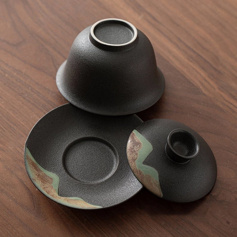 top view of ceramic gaiwan lid with landscape carving