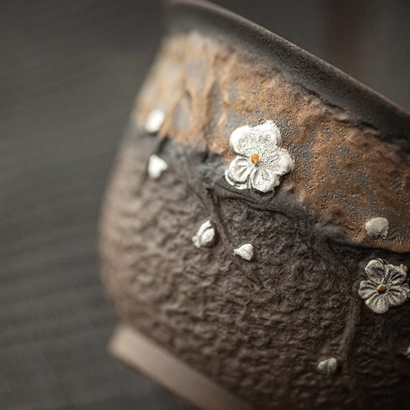 Gaiwan tea cup lid showing branch knob detail on plum blossom design