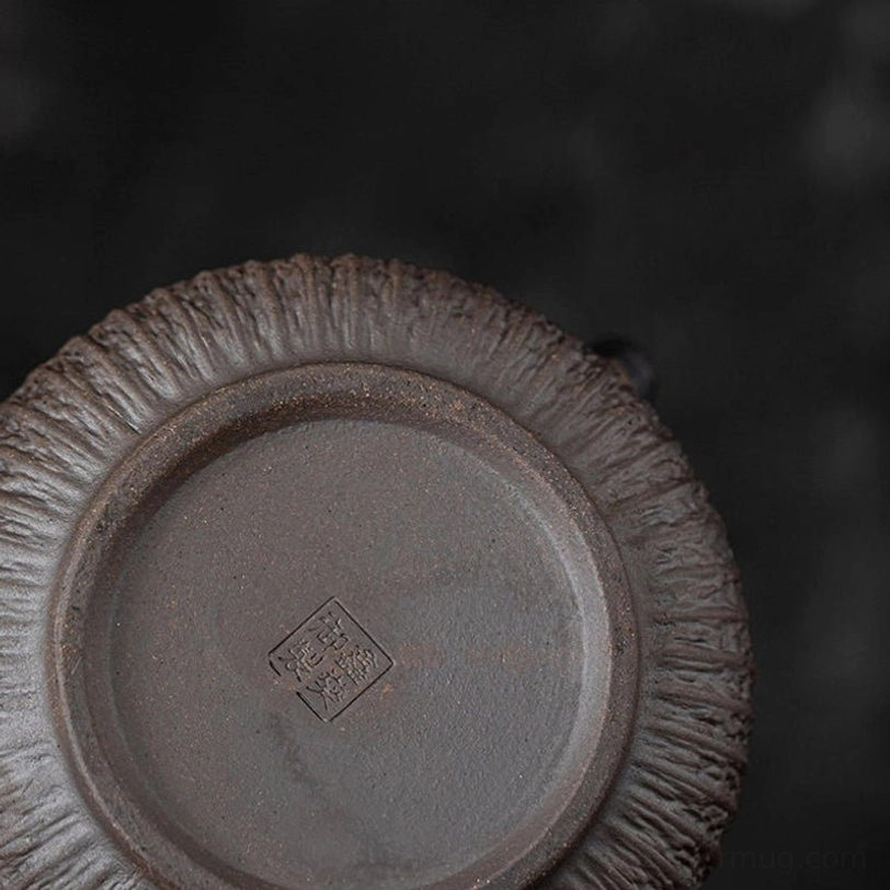 textured body detail of gilded iron glaze teapot