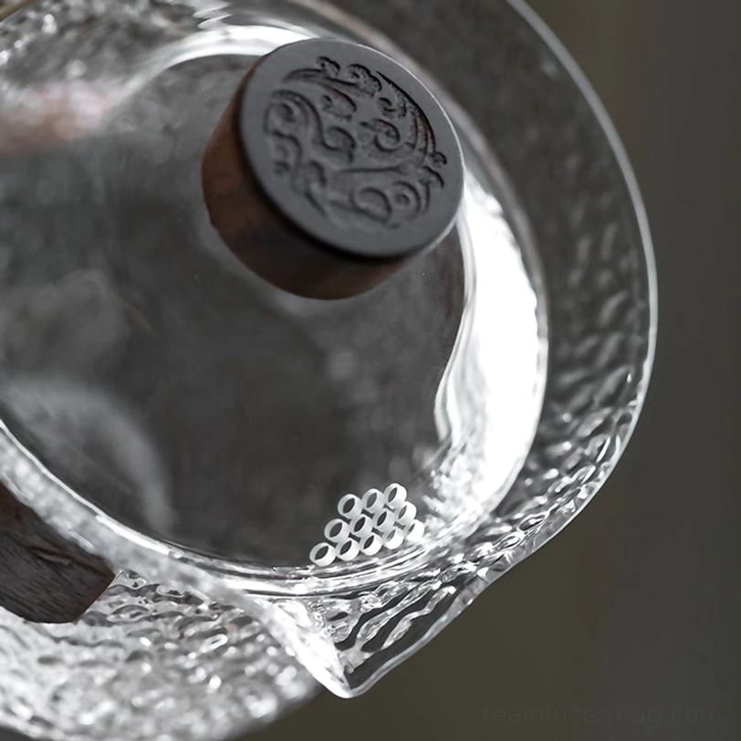 hammered glass gaiwan placed on wooden table for daily tea