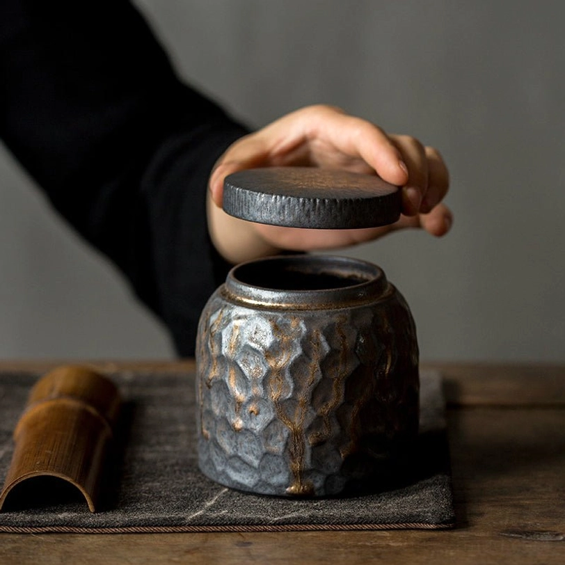 ceramic tea storage canister showing gold flow glaze detail