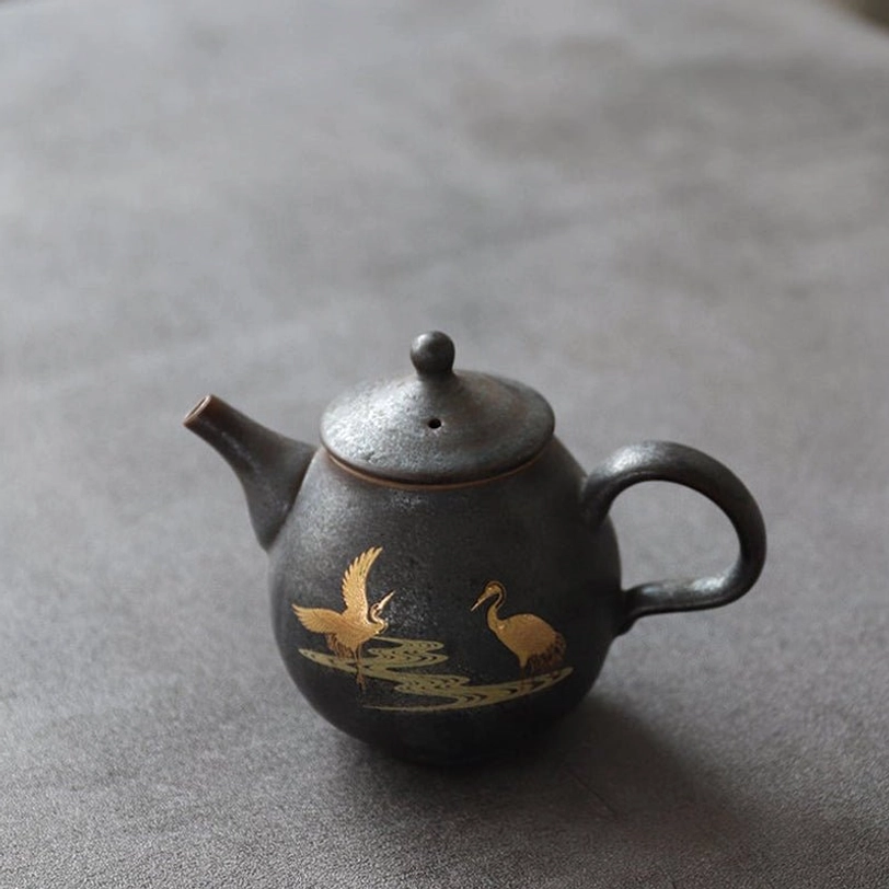 side view of black ceramic teapot with golden crane pattern 230ml