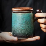 full view of gradient green crackle ceramic tea mug with infuser and wooden lid
