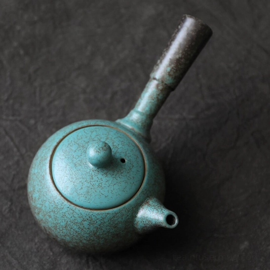 green ceramic kyusu teapot with infuser top view showing lid vent
