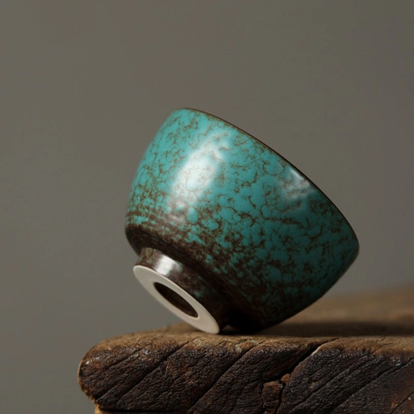 bottom base view of green ceramic tea cup showing finished brown glaze