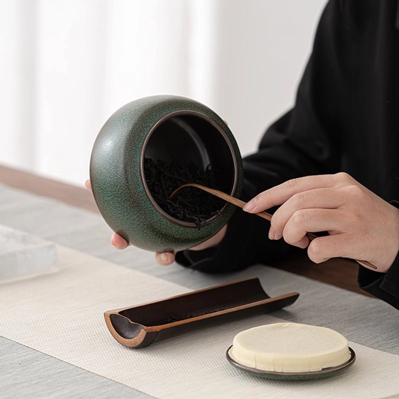 green ceramic tea storage canister base closeup