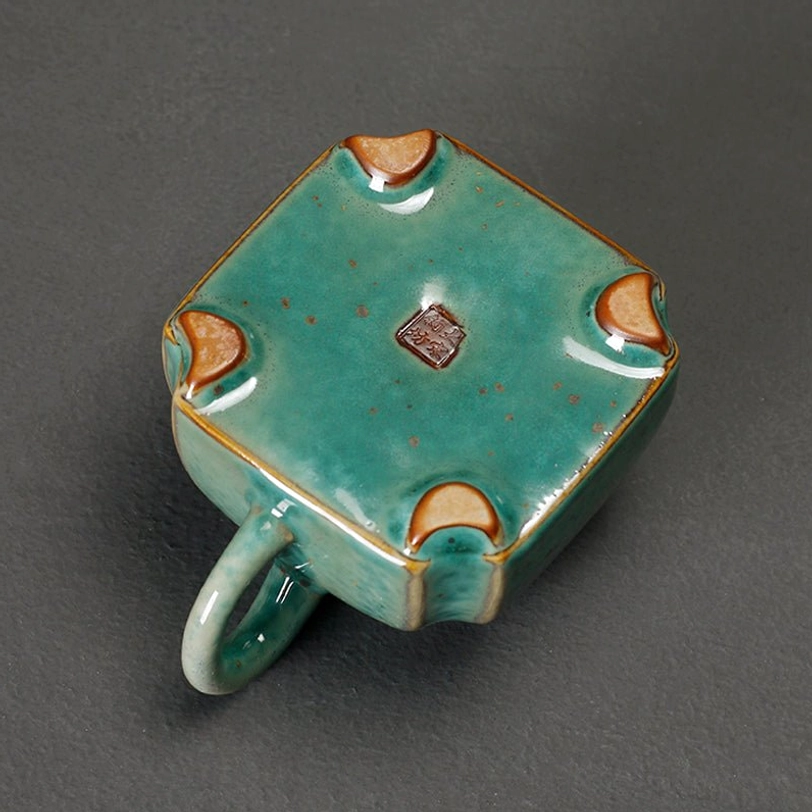 elephant teapot resting on a wooden tea table