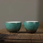 full side view of vintage green porcelain chinese tea cup with natural crackle glaze