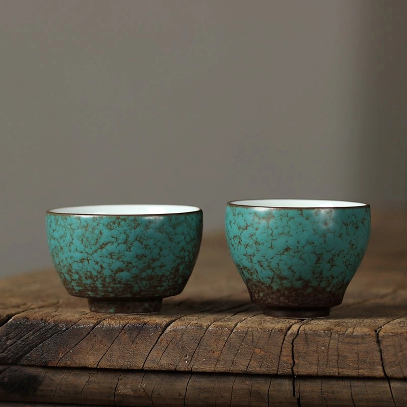 full side view of vintage green porcelain chinese tea cup with natural crackle glaze