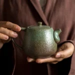 full side view green 300ml rustic ceramic teapot with infuser