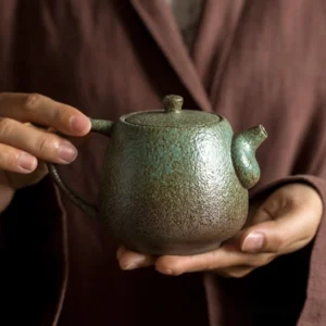 full side view green 300ml rustic ceramic teapot with infuser