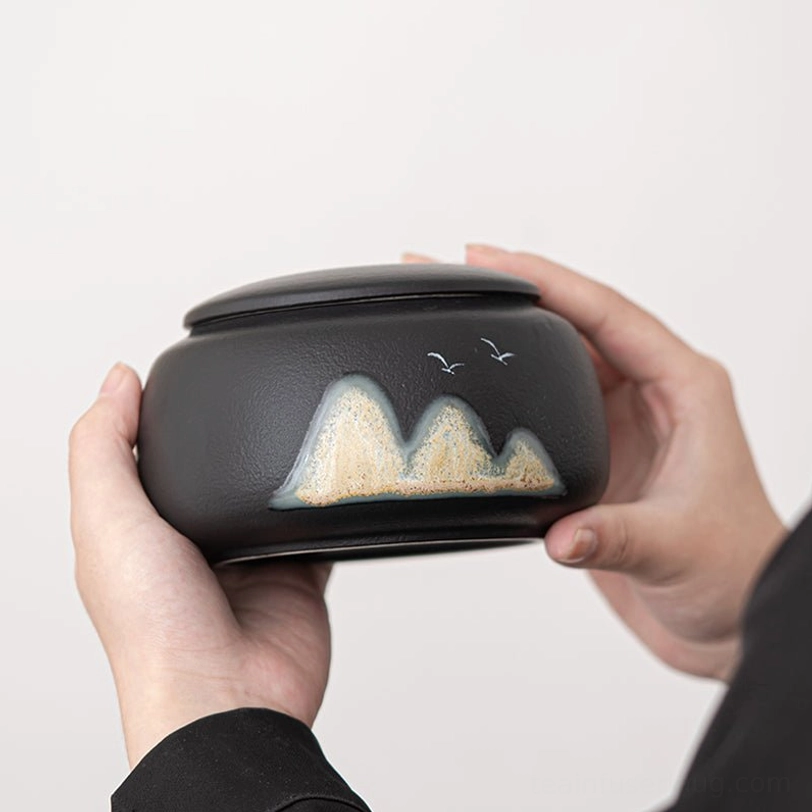 green textured ceramic tea storage canister on wood background