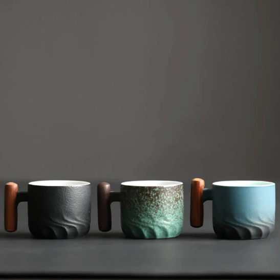 Green textured Chinese tea cup with wooden handle close up