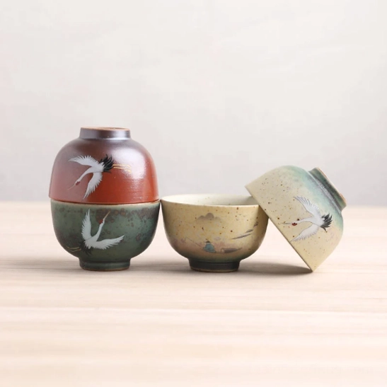 Hand-painted traditional motifs on ceramic Chinese tea cups and matching tea caddies