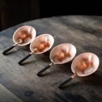 Full set of handcrafted hammered brass tea strainers with wood handle, multiple decorative styles