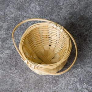 Handwoven natural bamboo tea strainer basket with handle side view