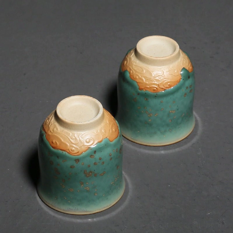 holding 120ml chinese porcelain teacup in hand