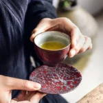 collection of iron rust glaze chinese tea cups with matching saucers