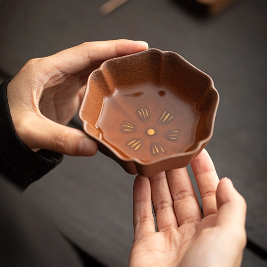 close up of inner floral pattern of japanese clay tea cup with tea