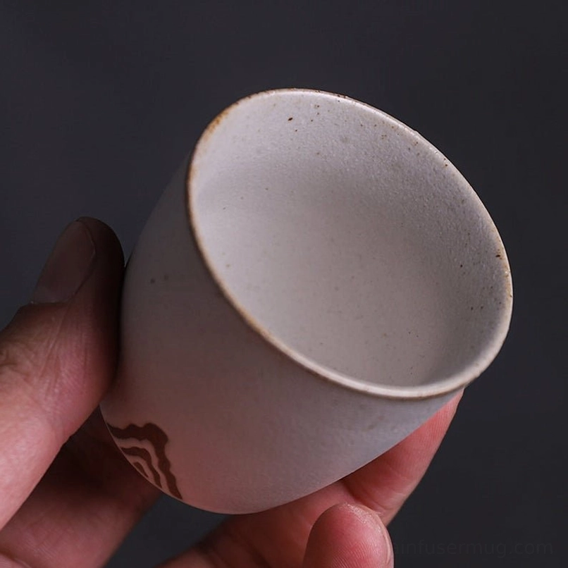 close up of japanese zen tea cup rim showing natural earthy glaze