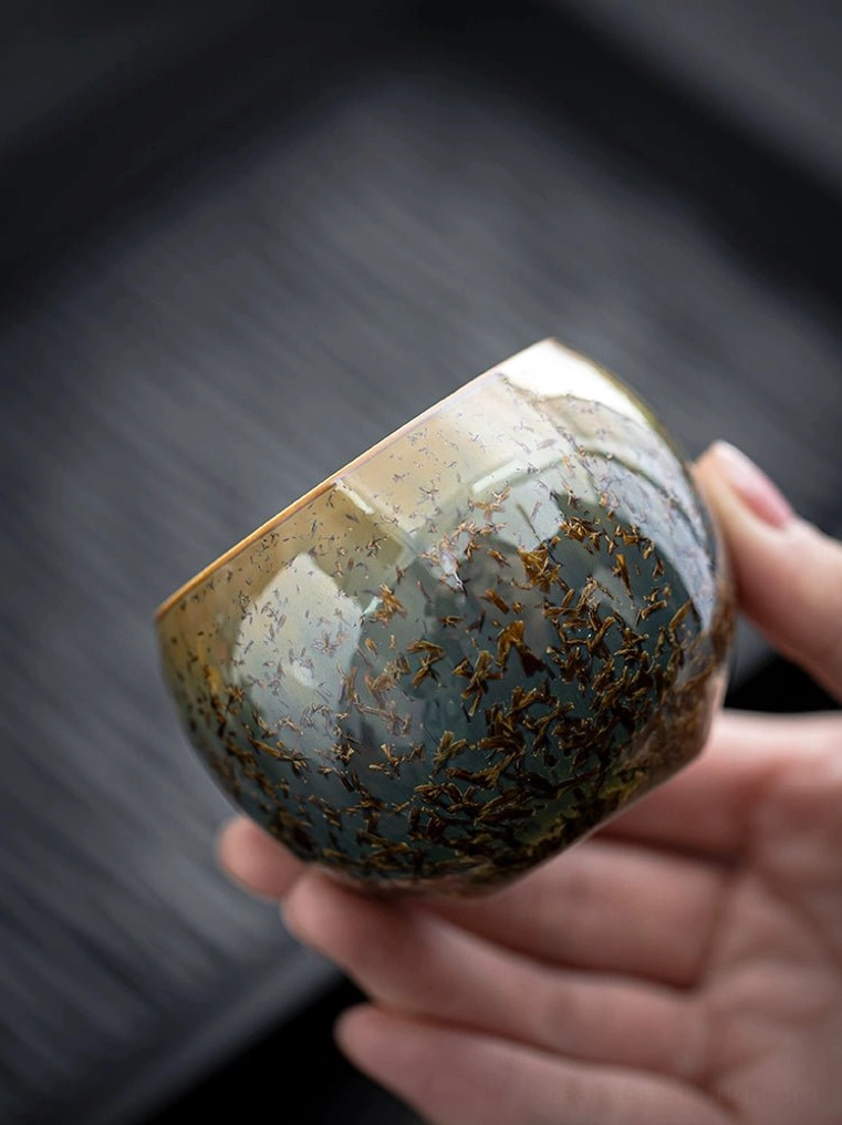 close up of blue green glaze pattern on jian zhan kiln change tea cup