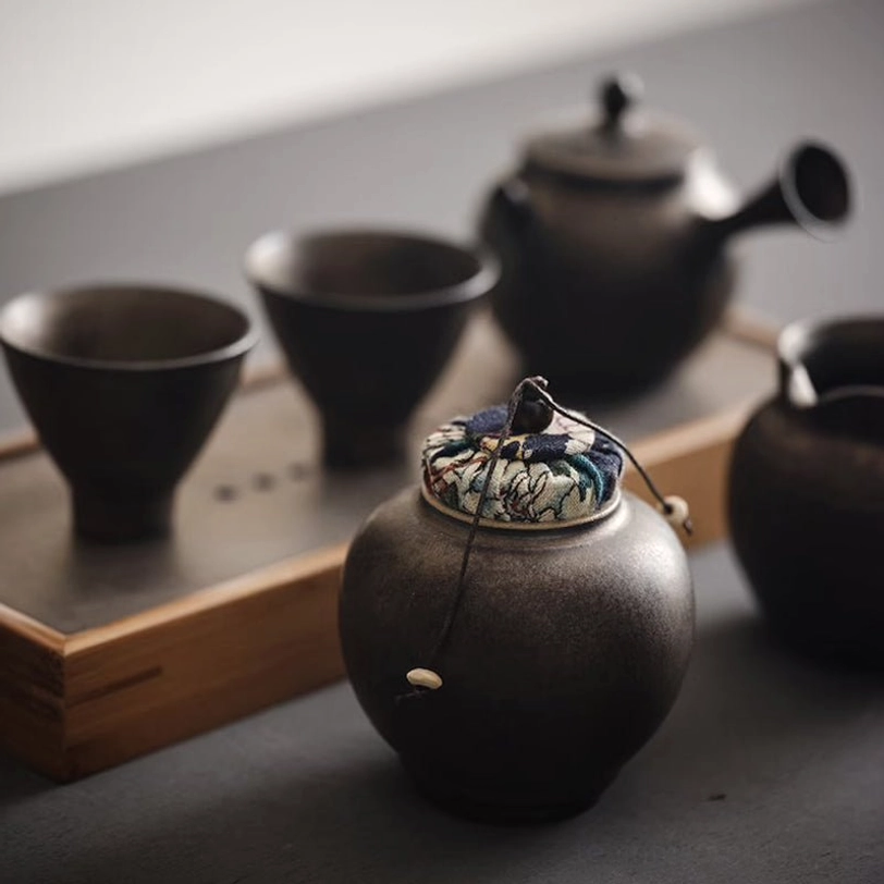 top view of knotted cord closure on ceramic tea canister lid
