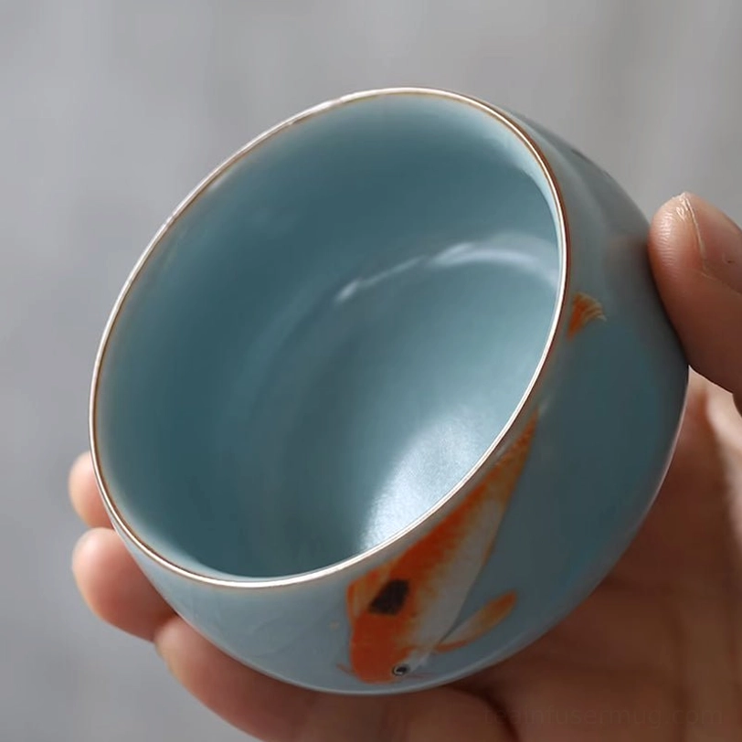 side view of three different styles of koi porcelain tea cups