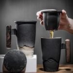 full product view of 350ml gradient landscape relief ceramic tea mug with strainer wood handle