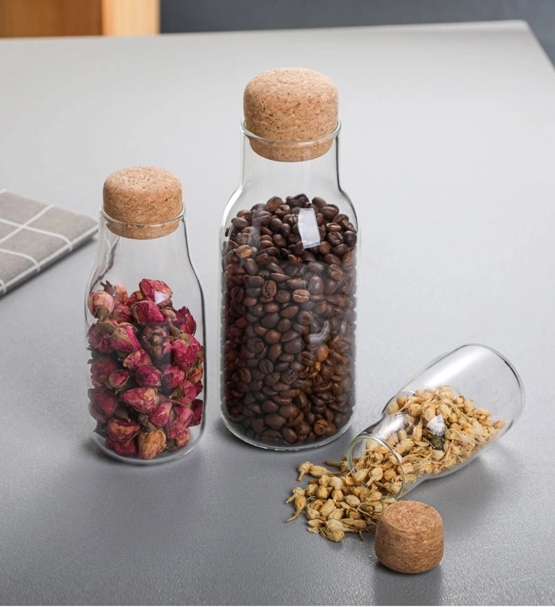 large clear glass tea storage canister on kitchen countertop