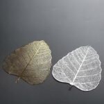 Leaf shaped stainless steel tea strainer placed on teacup for loose tea