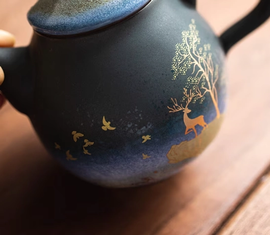 lid of gradient ceramic teapot with infuser showing golden detailing