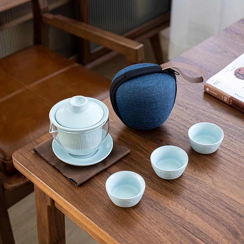 Light blue ceramic travel tea set arranged for brewing tea