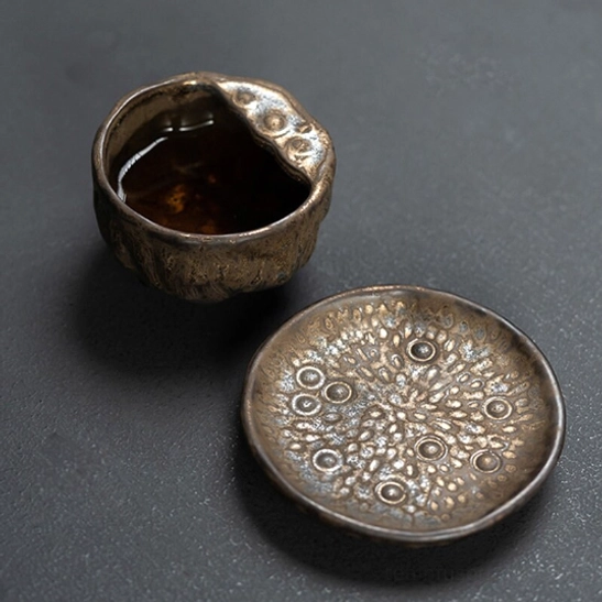 chinese lotus ceramic teapot pouring brewed tea into a cup