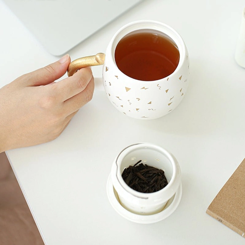 lucky cat tea mug with ceramic tea infuser placed inside