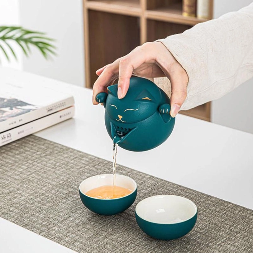 close up of maneki-neko lucky cat teapot face with gold detailing