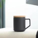 matte black ceramic tea infuser mug with natural wooden lid front view
