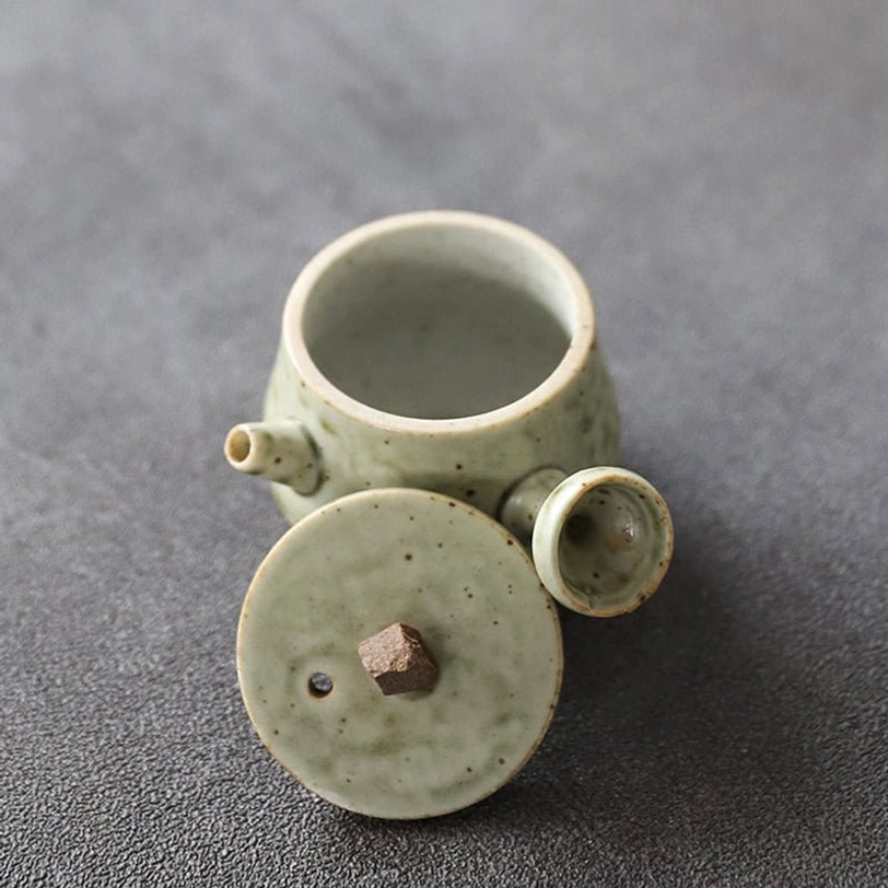 size comparison of 25ml mini ceramic teapot with human hand