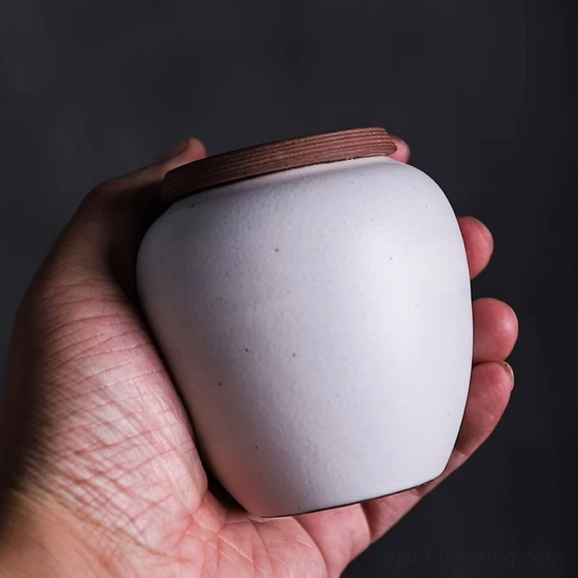 portable mini tea canister held in hand to show size