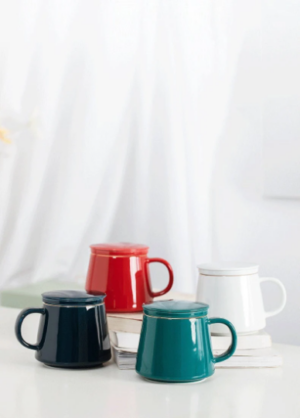 Side view of minimalist ceramic tea infuser mug with lid