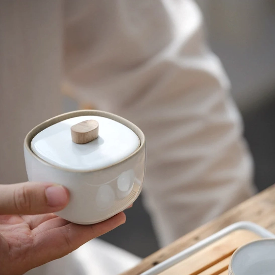 minimalist ceramic tea storage jar on wooden table