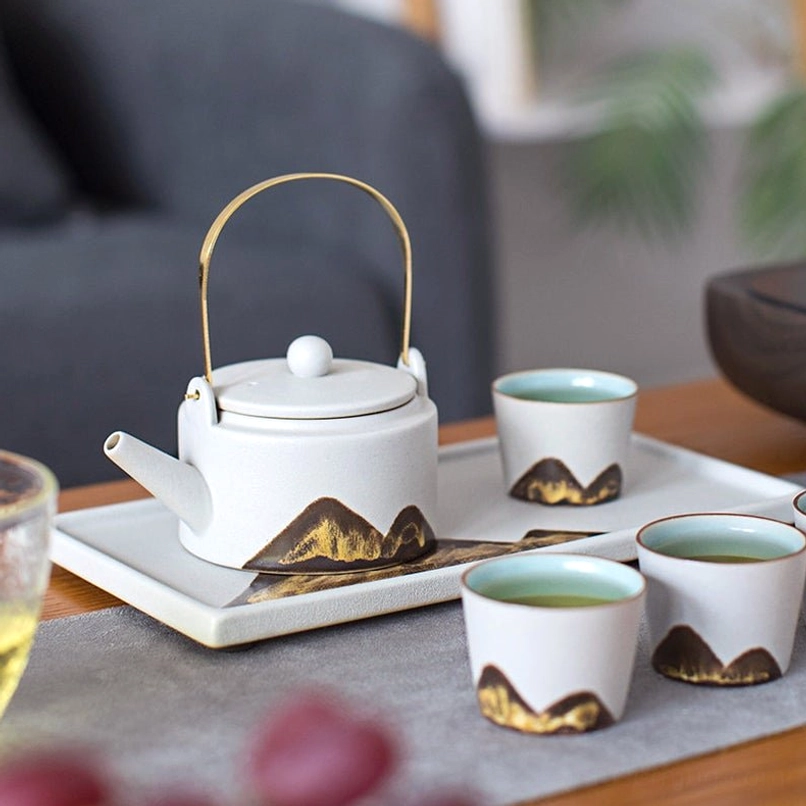 mountain ceramic teapot placed on matching tea tray