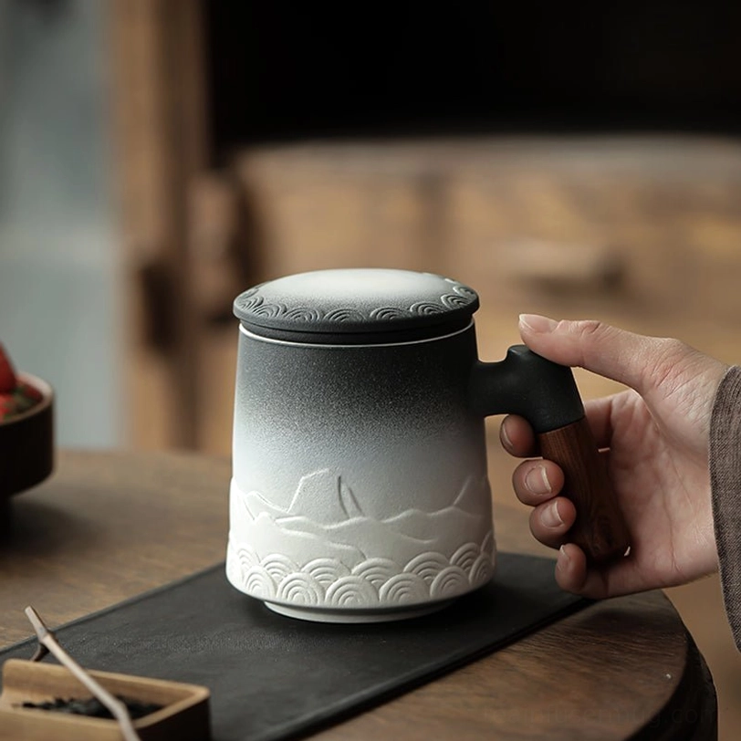 close up of mountain wave relief carving on ceramic tea infuser mug