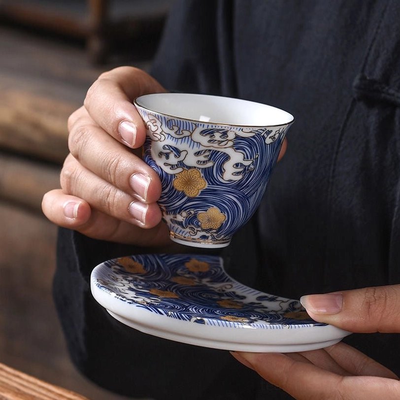 Multiple matching blue gold Chinese tasting tea cups in gongfu set