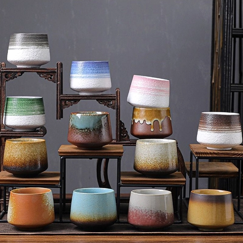 multiple large chinese ceramic tea cups on display shelf