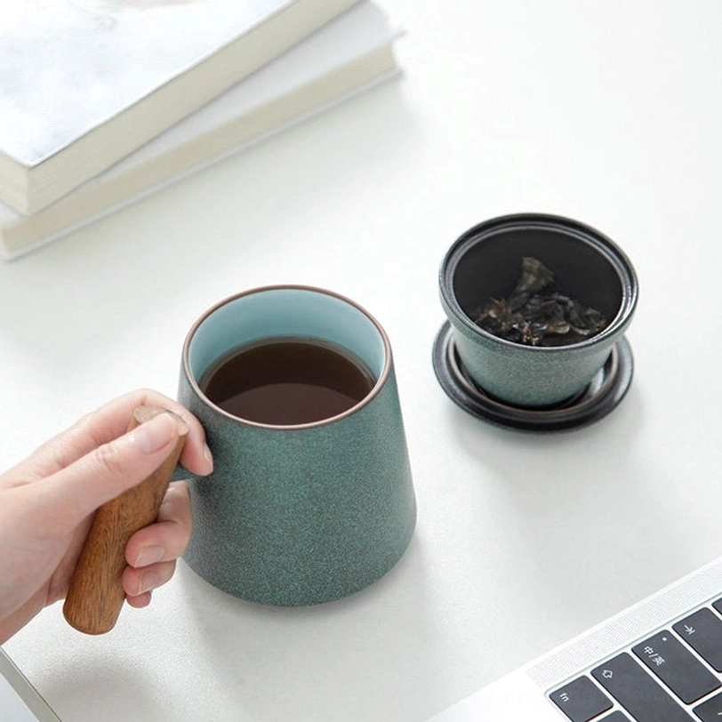 close up of natural solid wood handle on ceramic tea infuser mug