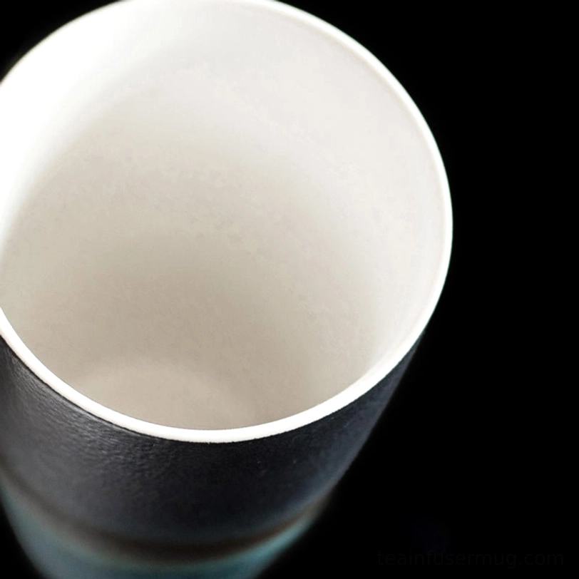 close up of natural wood handle texture on ceramic tea infuser mug