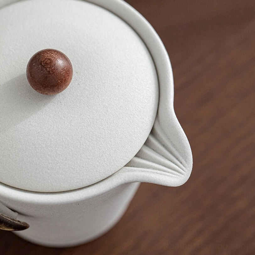 Nesting design of travel tea set showing two teacups inside teapot